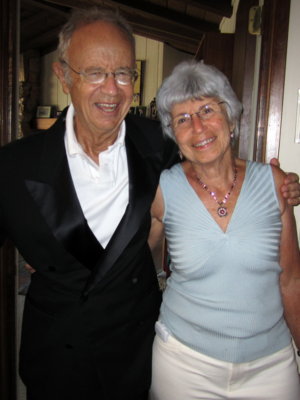 Photograph of Andy and Eva Grove standing; Andy's arm is around Eva and they are both smiling